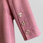 This gorgeous luxury rose twill blazer with subtle check pattern is cut in a slightly fitted silhouette and is simply decorated with charming sculptural buttons imitating pearls shells (single-button front closure and three buttons on the cuffs). It's fully lined with smooth satin printed with signature Givenchy logo.